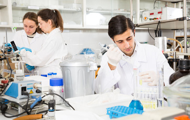 Man pipetting reagent in test tube