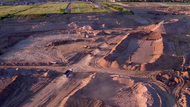 Extraction of construction sand at the quarry. Loading construction sand in trucks.