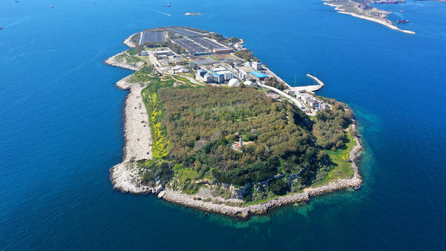 Aerial drone bird's eye view photo from island of Psitaleia the largest sewage treatment plant in Europe, Saronic gulf, Peiraeus, Attica, Greece