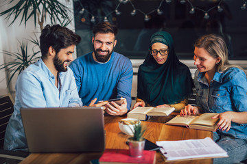 Group of students of diverse ethnic learning at home. Learning and preparing for university exam, selective focus.
