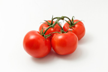 Ripe tomatoes isolated on white background. Four whole vegetables with sepals