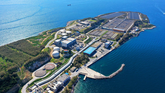 Aerial drone bird's eye view photo from island of Psitaleia the largest sewage treatment plant in Europe, Saronic gulf, Peiraeus, Attica, Greece