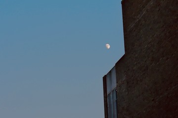 Moon next to building