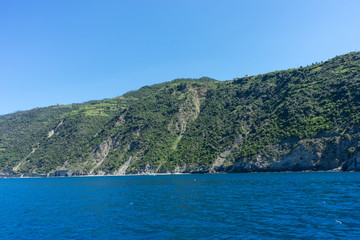 Italy,Cinque Terre,Riomaggiore, a large body of water with a mountain in the background