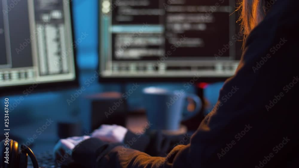 Poster cybercrime, hacking and technology concept - female hacker in dark room creating code or using compu