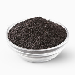 Bowl with black sesame seeds on white background