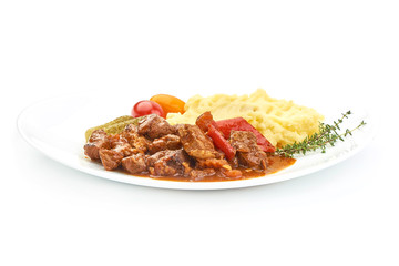 Beef stew, traditional homemade European meat goulash, Hungarian bograch, close-up, isolated on white background