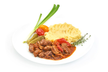 Stewed Beef meat, traditional homemade European goulash, Hungarian bograch, close-up, isolated on white background