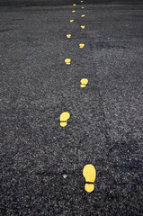 Yellow footprints painted on asphalt in Vienna, Austria