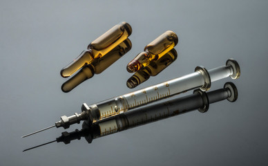 Vintage syringe with vials, conceptual image