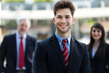 Business team smiling outdoor in a modern urban setting