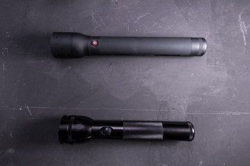 Two large flashlight. Police flashlights. Black lanterns.