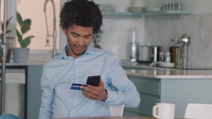 happy man using smartphone shopping online spending money on credit card mobile banking app with digital currency enjoying financial freedom