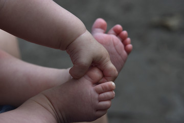baby legs and handles close up on gray background