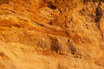 bright orange surface of the soil with sand, background, texture