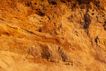 bright orange surface of the soil with sand, background, texture