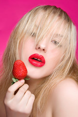 Sexy Woman Eating Strawberry. Sensual Red Lips. Sexy red Lips with Berry