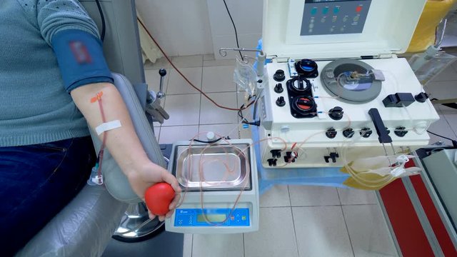 Modern machine works in a transfusion center, pumping blood.