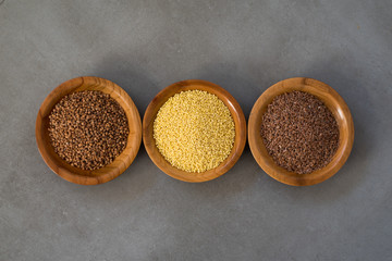 Collection of different groats, buckwheat, flax, in bowls. Set of Groats and Grains.