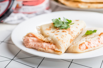 pancakes with filling on a white plate