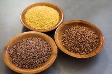 Collection of different groats, buckwheat, flax, in bowls. Set of Groats and Grains.