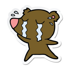 sticker of a cartoon crying bear