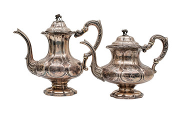 Two antique teapots of silver in Oriental style on a white background.