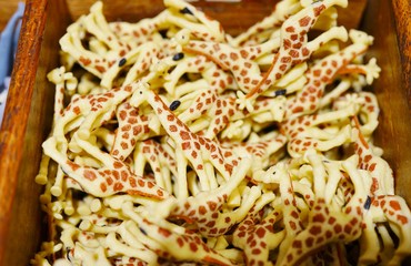 View of a bin filled with plastic giraffes in a toy store