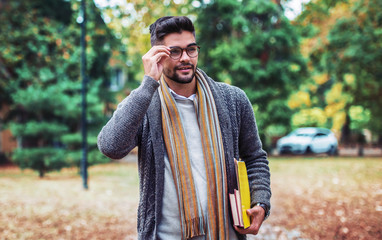 Obraz premium Campus life. Young student with a books. Education, fashion, lifestyle concept