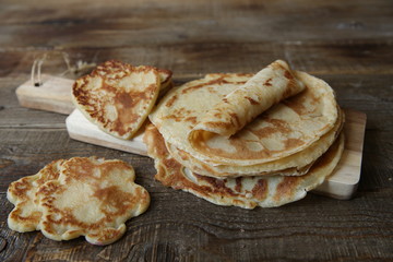 pancakes on a board on a rustic wooden table with space for text