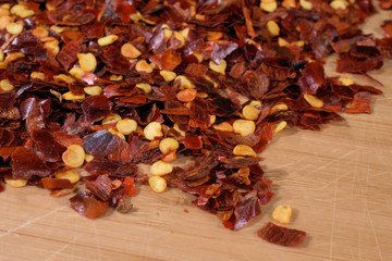  Red pepper spice on wood background