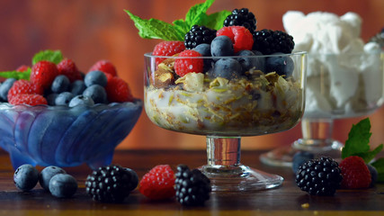 Grain free oat free paleo diet granola breakfast served with fresh seasonal berries, coconut milk, and coconut yoghurt.