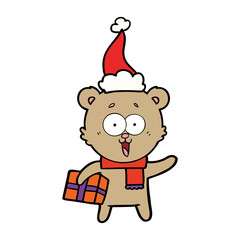 laughing teddy  bear with christmas present wearing santa hat