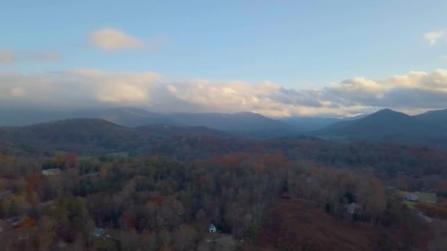 205 Aerial panning revealing mountain houses and lake Autumn