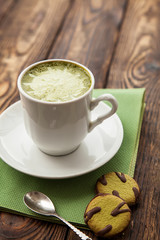 cup of Matcha tea and green cookies on a green napkin