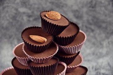 Keto Chocolate Almond Butter Fat Bombs. Paleo diet chocolate isolated on grey background