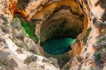hole in the rock with water underneath