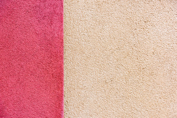 Fototapeta premium The plaster of a house facade in pink and cream colors