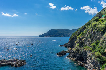 Italy, Cinque Terre, Vernazza, a body of water with a mountain in the background