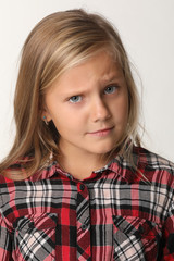 Close up of a portrait of a girl with blue eyes and blond hair. White background
