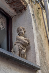 Italy, Cinque Terre, Vernazza, LOW ANGLE VIEW OF STATUE AGAINST BUILDING