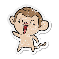 distressed sticker of a cartoon laughing monkey