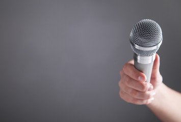 Hand holding microphone.