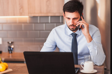 Young businessman working on laptop at home