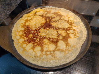 Crepe cooking in a frying pan