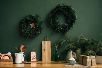 Two beautiful Easter wreaths of pine are hanging on the background of a green wall.