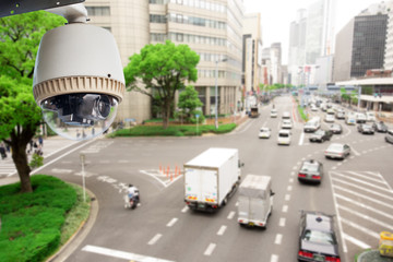 CCTV Surveillance camera operating on traffic road and people cross road in japan