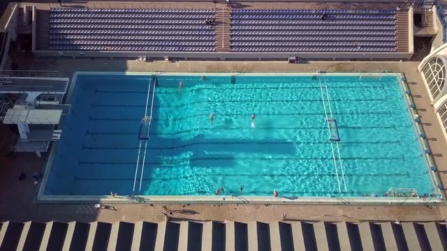Swimming people play waterball. Top view