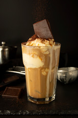 Ice-cream and coffee cocktail in glass. summer, refreshing coffee drink over black background.