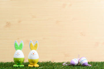 Easter decorative background on grass and wooden floor